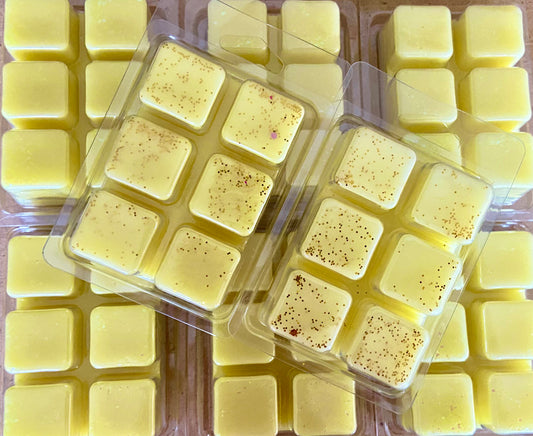 Packaged yellow Citronella Bug Repellent Wax Melts with specks of color, arranged in plastic containers by The Soap Gal x.