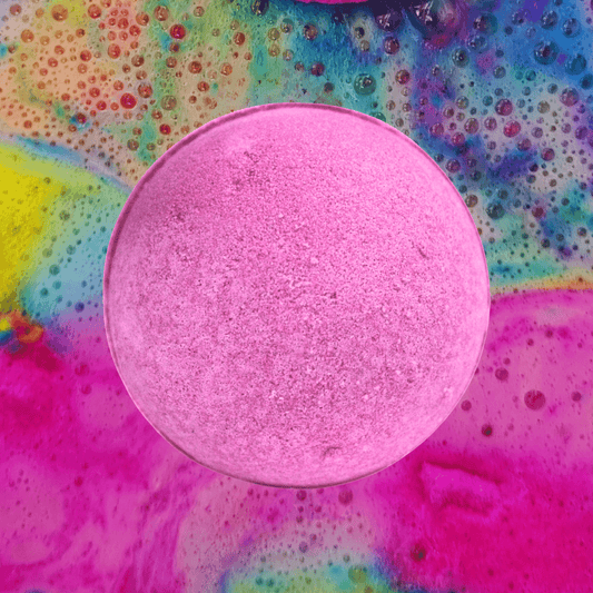 A colorful background with a fizzy, pink The Soap Gals Bubblegum Bath Bomb in the center, exuding a sweet edible smelling accord.