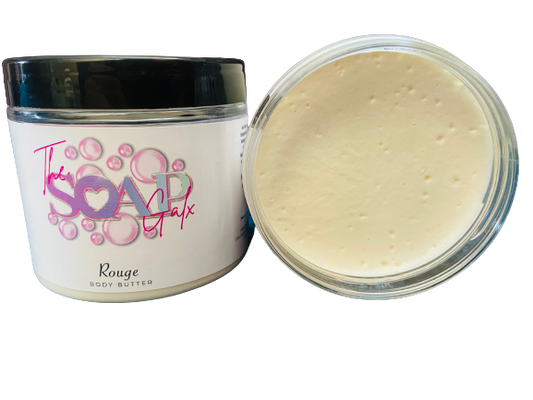 A jar of "The Soap Gals Women's Perfume Inspired Body Butter & Moisturiser 200ml" next to its open lid showing the creamy product inside.