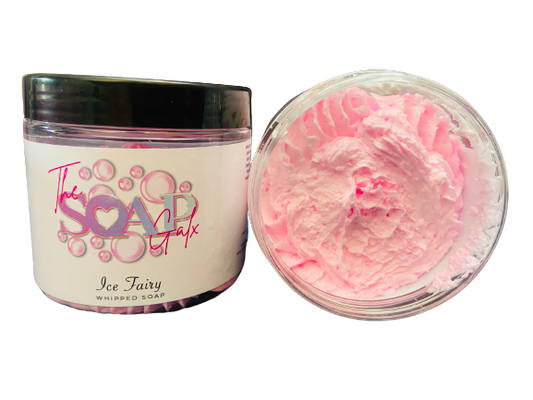 A jar of "Women's Perfume Inspired Whipped Soap" by The Soap Gals with its lid open, displaying a pink, creamy textured shave butter product.