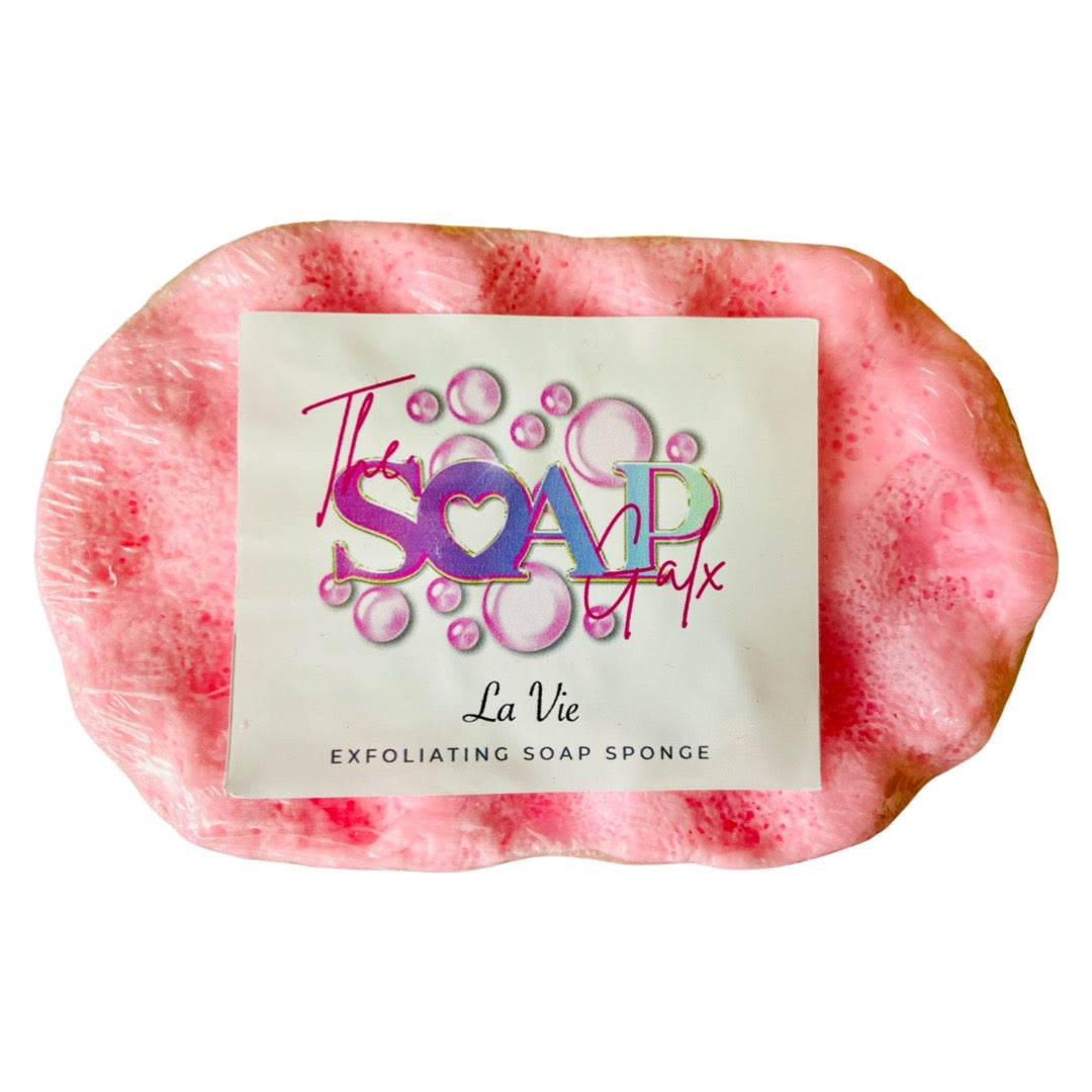 A pink Perfume Soap Sponges bar with a exfoliating label on it from The Soap Gals.
