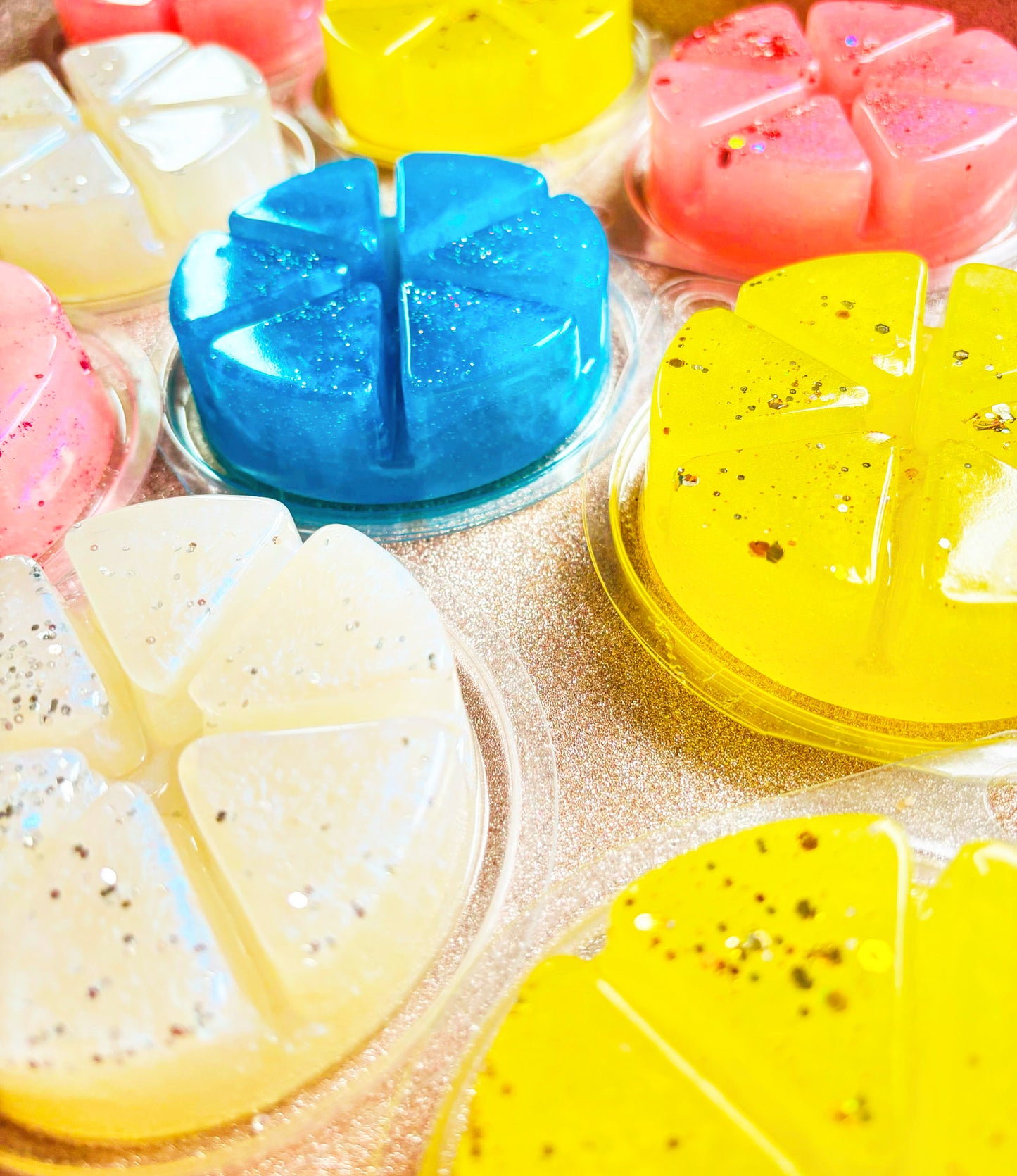Colorful assortment of Gel Wax Melts 100g sprinkled with glitter, displayed closely together, featuring vibrant hues of blue, pink, yellow, and white from The Soap Gal x.