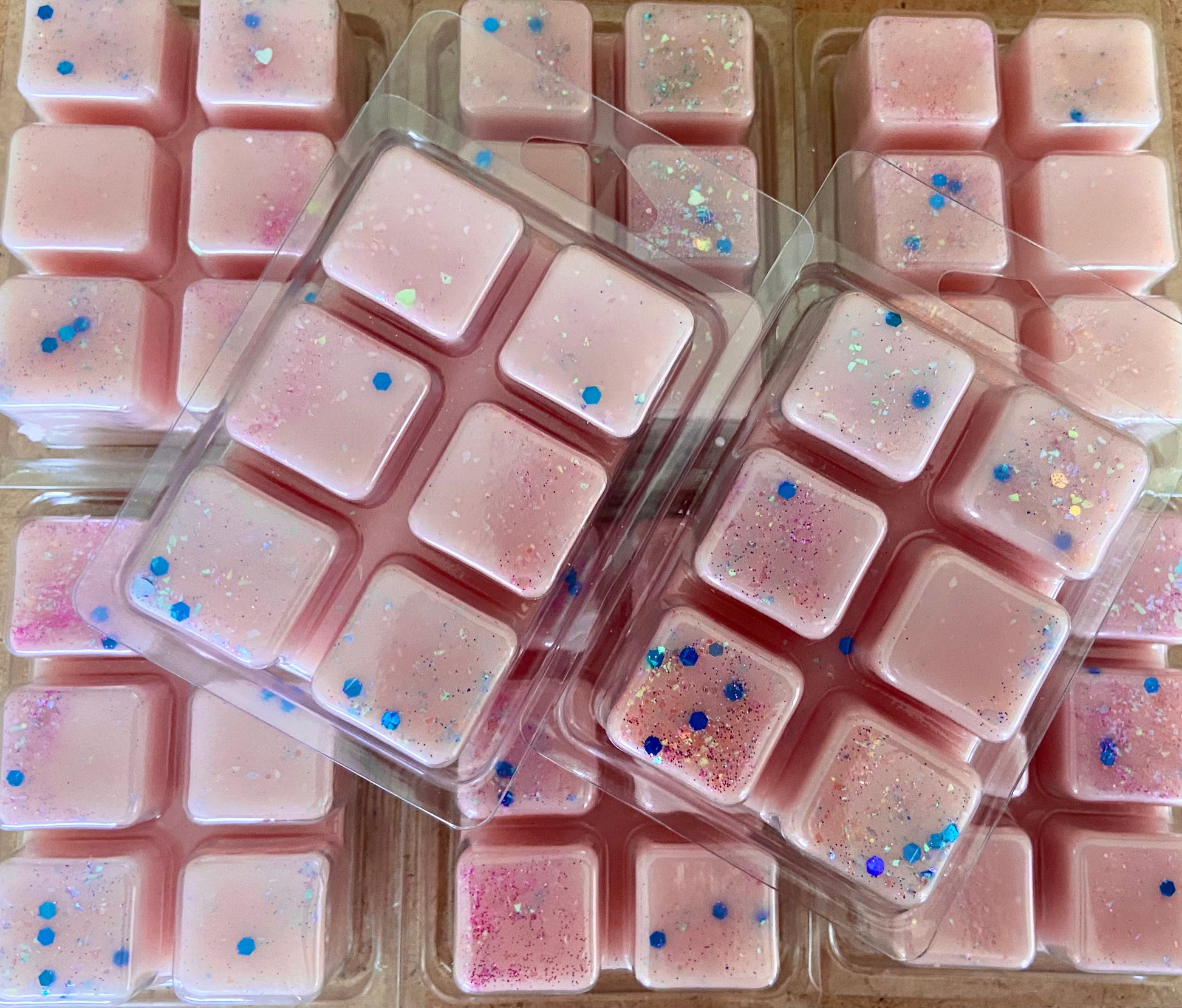 Packages of pink sprinkle-covered fudge neatly arranged, emitting a calming The Soap Gals Baby Powder Wax Melt Snap Bar aroma.