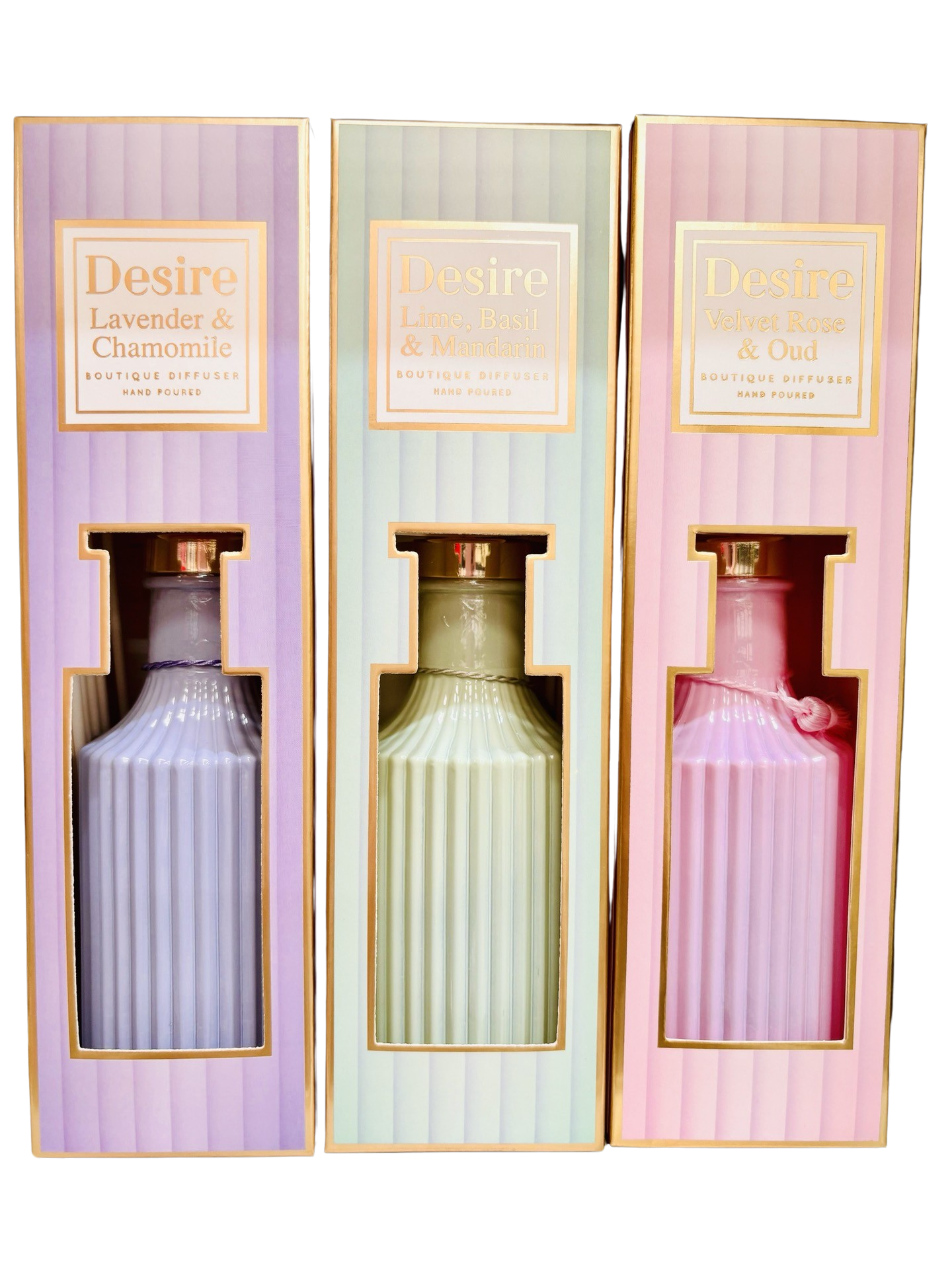 Three bottles of "150ml Reed Diffuser Pastel Colours" eau de parfum from the Opulence Collection in a display case, each labeled with different scents: lavender & chamomile, lemon basil & mint by The Soap Gal x.