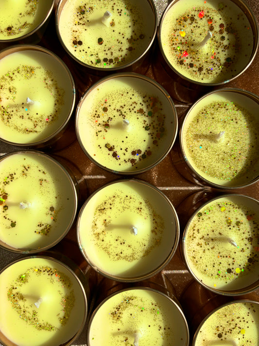 Top-down view of multiple cups of traditional Indian sweet dish, rasmalai, garnished with crushed pistachios and colorful sprinkles, displayed outdoor.