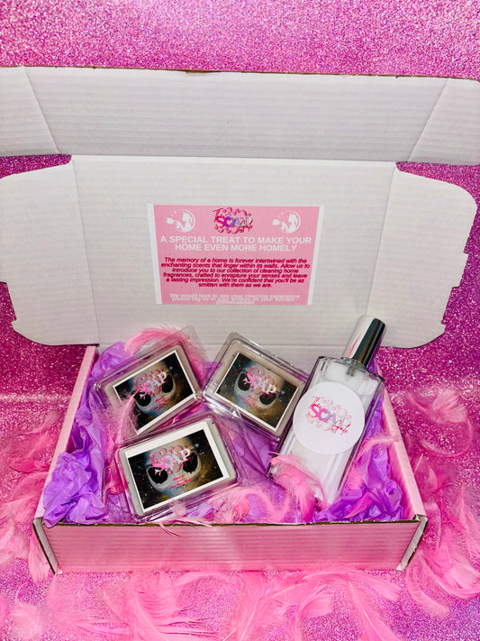 A luxurious fragrance set in a pink box featuring a bottle of Aliens Wax Melt - 3 Wax Melts & 1 Room Spray from The Soap Gal x and an accompanying box of tampons.