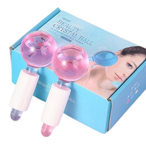 Two The Soap Gal x Cooling Facial Massage Ice Globes 2 Pack with pink handles and transparent pink spheres, displayed next to their packaging box.