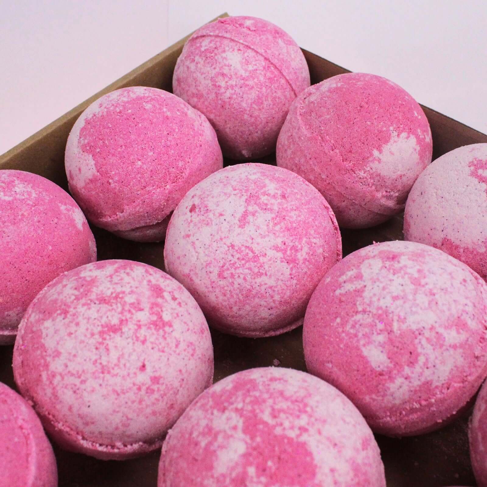 A collection of The Soap Gals Bubblegum Bath Bombs, with a sweet edible smelling accord, arranged neatly in a box.