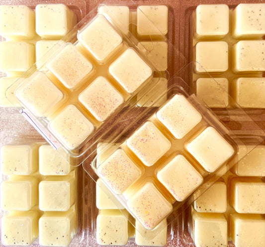 Packaged square Flower Explosion Wax Melts with colored speckles and subtle patchouli notes, viewed from above, by The Soap Gals.