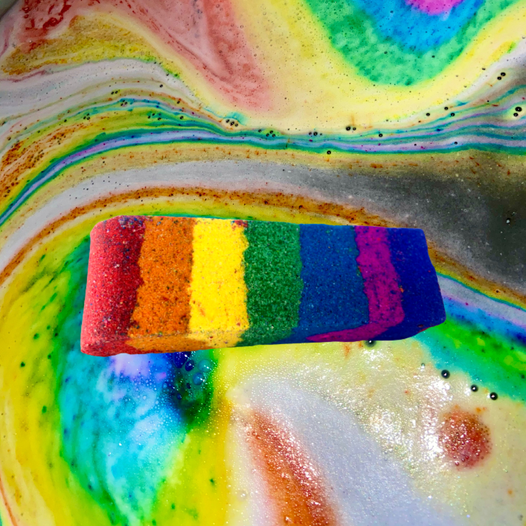 An image of a Rainbow Stick Bath Bomb from The Soap Gals in a bowl with a luxury fragrance.
