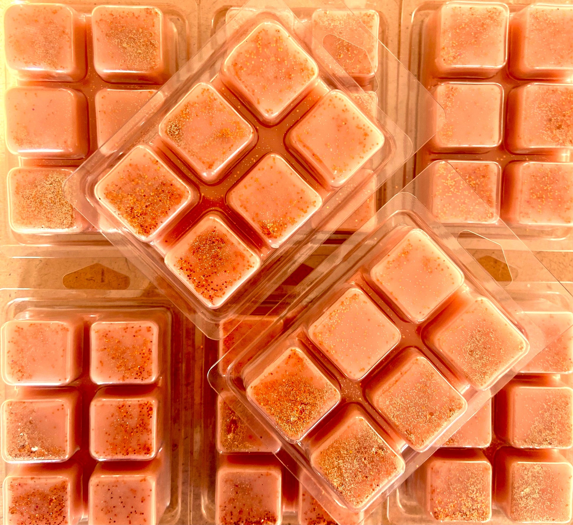 Several plastic clamshell packs containing Sticky Toffee Pudding Wax Melt by The Soap Gal x are arranged closely together.