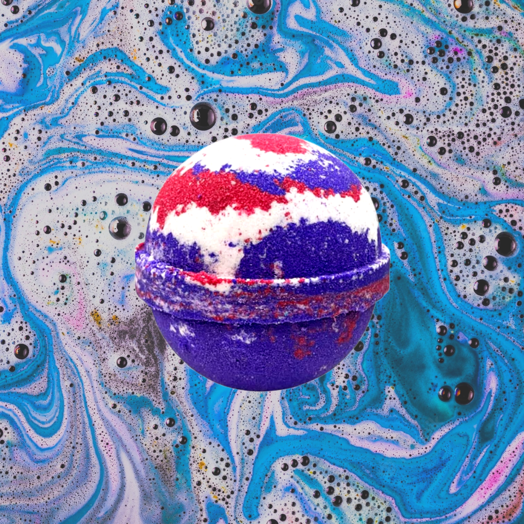 A Vimto Bath Bomb from The Soap Gals dissolving in water, creating a swirling pattern of blue and purple with hints of red and white.